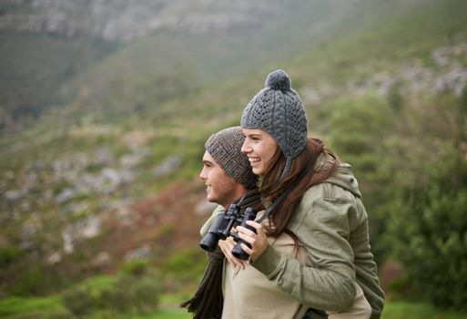Creating memories in the great outdoors. A young couple taking in all the scenary while enjoying a mountain hike.