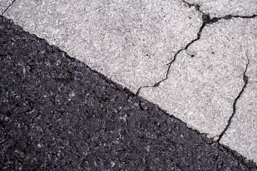 Close-up the cracked on the surface of Road Line painted