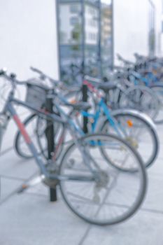 Ready to ride. Blurred shot of a bicycles at a bicycle rack in a city.