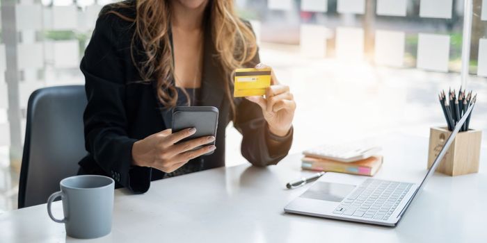 Woman using shopping application on smartphone and payment by credit card.