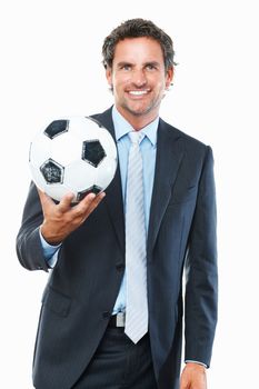 Executive holding football. Portrait of business man holding a football against white background.