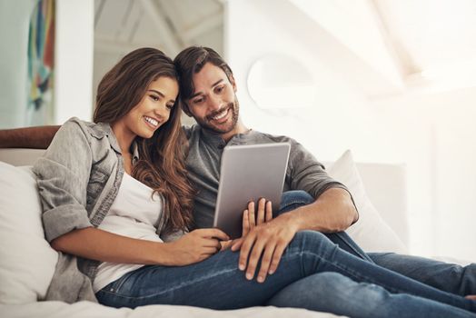 Connecting with loved ones became oh so easy. an attractive young couple spending quality time at home.
