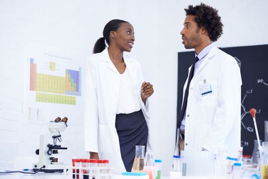 Having a friendly discussion in the lab. two scientists having a discussion in their lab.