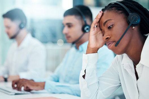 Headache, call center and burnout with a black woman in telemarketing looking tired or exhausted. Consulting, compliance and customer service with mental health issues of a female crm representative