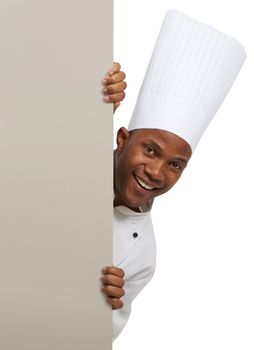 Advertising his new restaurant. Portrait of an african chef standing behind copyspace.