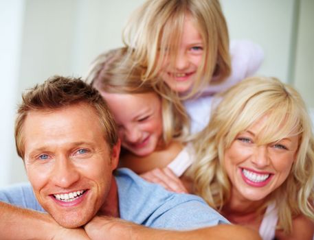 Cheerful mature man with his family having fun together. Portrait of a cheerful mature man with his family having fun together.