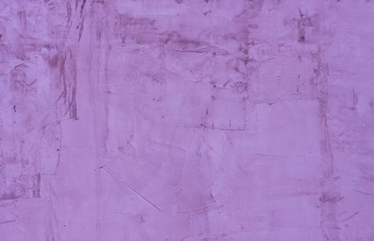 Abstract background of old plaster on a lilac wall.
