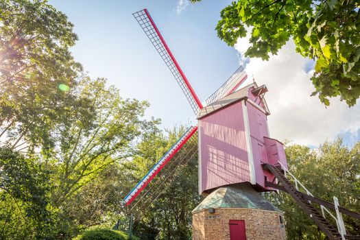Rustic wooden windmill in idyllic Bruges public park, Belgium