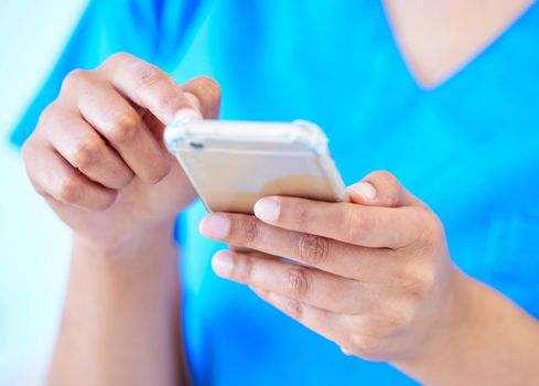 Those fingers move fast. a female dental assistant using her smartphone to send a text.