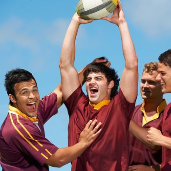 The faces of winners. a young rugby team celebrating a victory.