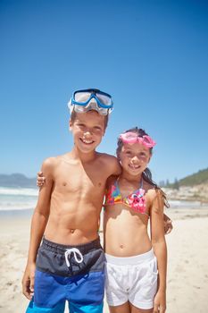 Making the most of their summer holidays. Portrait of a brother and sister standing together on the beach.