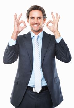 Executive giving ok sign. Portrait of smiling business man giving ok sign against white background.