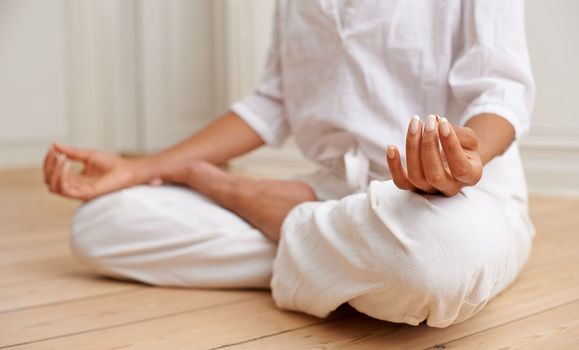 Stress free zone. a woman sitting in the lotus position during a yoga session.