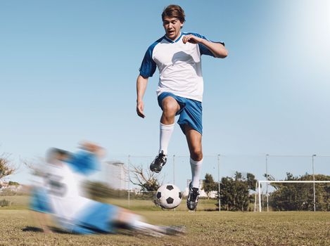 Soccer, tackle and motion blur with a sports man running on a field during a competitive game or training. Football, fitness or health and a male athlete or player on a pitch with an opponent