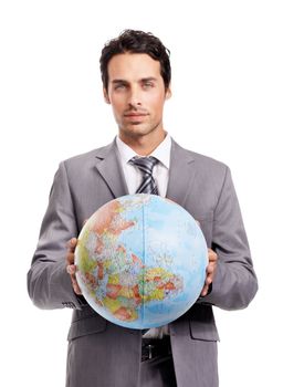 Going global. A handsome young executive holding a globe while isolated on a white background.