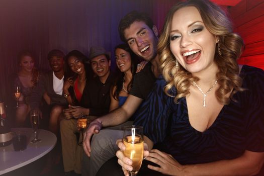Champagne, party and group of friends at nightclub to celebrate new years event. Luxury celebration, diversity in friendship and happy hour at club for New Year gathering, portrait of woman at disco.