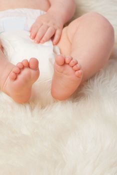 Hes got many steps to walk in life. a baby boys legs and feet in a studio.