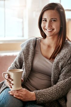 Smile, woman and coffee portrait at home on a living room sofa feeling calm and relax. House, tea and morning happiness of a person with a drink on a house lounge couch peaceful and smiling alone