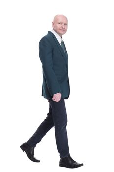 Mature business man striding forward. isolated on a white background.