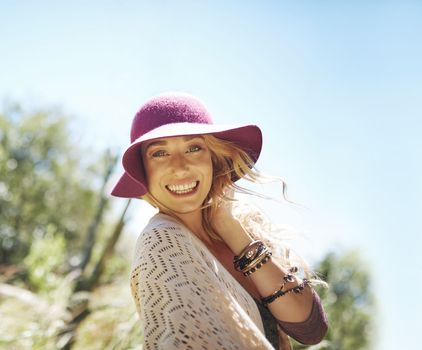 Happy and free is the only way for me. Portrait of an attractive young woman in a sunhat standing outside.