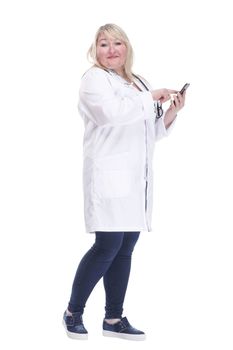 Mature woman doctor choosing contact in her smartphone .