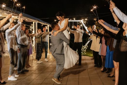 newlyweds at a wedding of sparklers