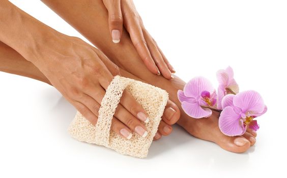 Spa, scrub and woman with cosmetics, feet and natural beauty for lady isolated on white studio background. Lady, flower and foot with skincare, cleaning and dermatology for luxury pedicure treatment
