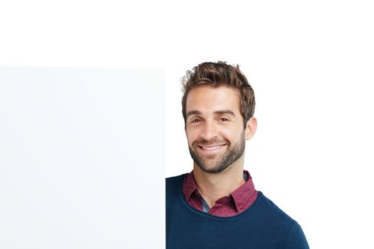 Portrait, studio and man with a board with mockup space for marketing, advertising or product placement. Happy, smile and male model with a banner, poster or signage isolated by a white background.