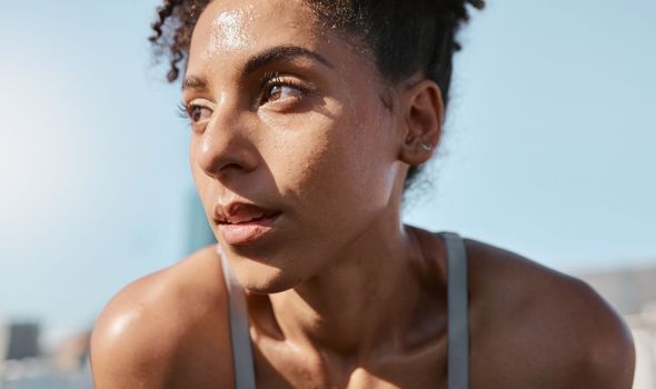 Face, sweat and fitness with a sports black woman tired after a cardio workout for fitness in the city. Running, exhausted and sweating with a female athlete or runner resting after exercise in town.