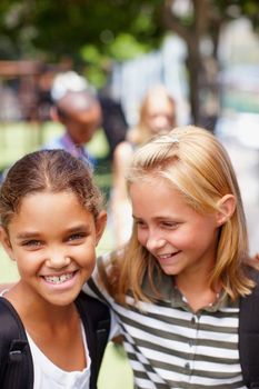 Shes my best friend. Elementary school girls of different ethnic groups standing close together smiling - copyspace.