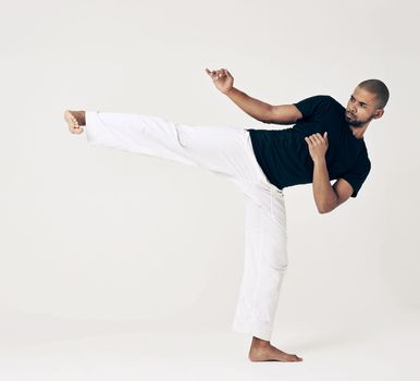 Im not a fighter, Im a martial artist. Studio shot of a young martial artist practicing.