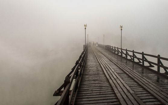 Mon wood bridge in the morning in the fog down (Sangkhla Buri, Kanchanaburi.