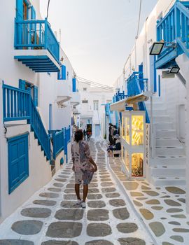 Tourist at the streets of Mykonos Greek village in Greece, colorful streets of Mikonos village