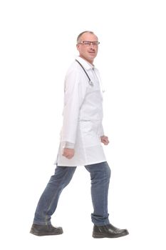 Middle age doctor with stethoscope walking on white background