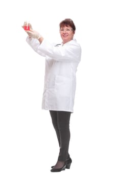 Side view of woman doctor dark hair in medical coat or scientist holding beaker with red liquid