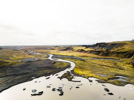Aerial view of river flowing trough Iceland volcanic landscape