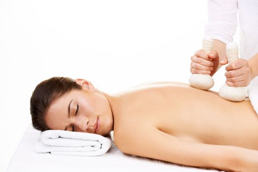 The perfect stress reliever. a young woman getting a beauty treatment isolated on white.