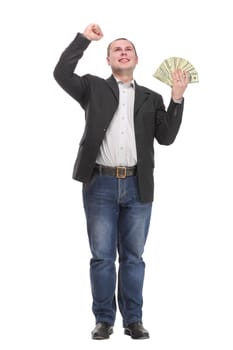 Happy young man holding money while standing and arm up