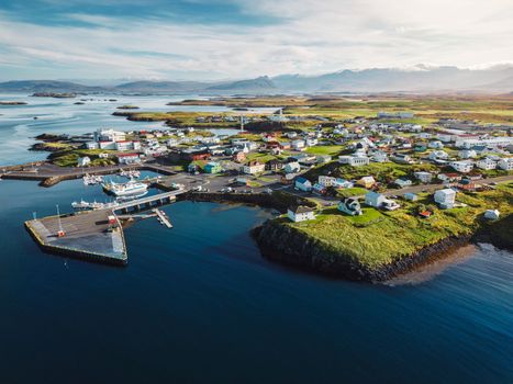 Aerial view of typical fishing village Stykkisholmskirkja Harbor in western Iceland in autumn 2022
