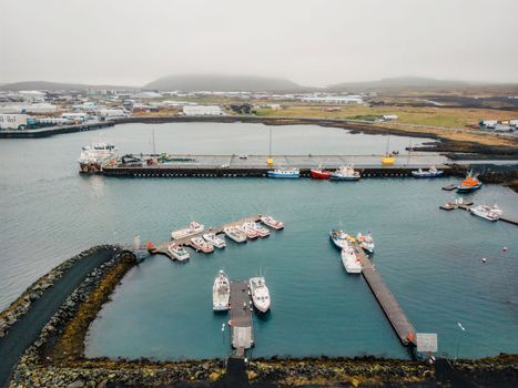 Grindavik, small fishing town, fishing boats docked on the pier on a cloudy autumn day