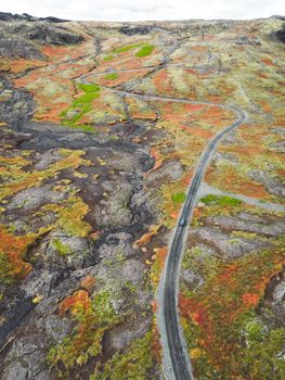 Curvy gravel road trough Icelandic highlands, drone aerial shot
