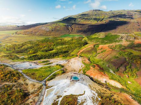 Vibrant green hills and nutrient rich land near geyser Strokkur in Iceland