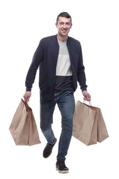 young man with shopping bags striding forward