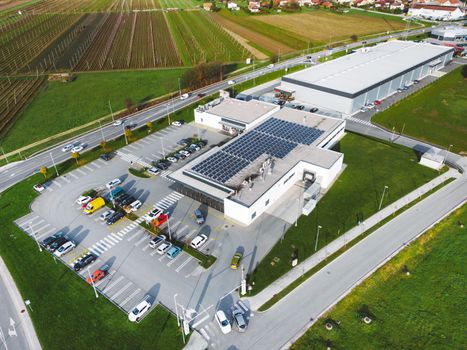 Aerial view of an industrial building with solar panels on the roof