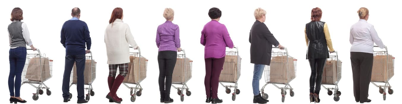 a group of people with a cart stand with their backs isolated