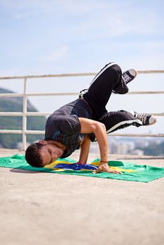 Capoeira- part of the Brazilian culture. Low angle shot of a young male breakdancer in an urban setting.