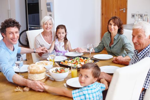 Home is where the heart is. a multi-generational family having a meal together.