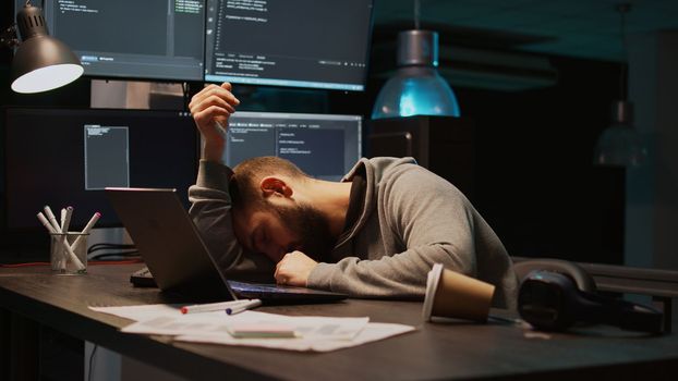 IT developer yawning and falling asleep on desk