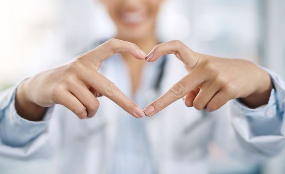 Your wellness comes first. Portrait of a young female doctor making a heart shape with her fingers.