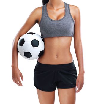 Football keeps her fit. a female soccer player isolated on white.